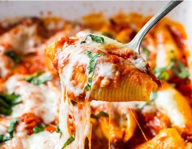 Cottage cheese stuffed shells topped with marinara sauce and herbs
