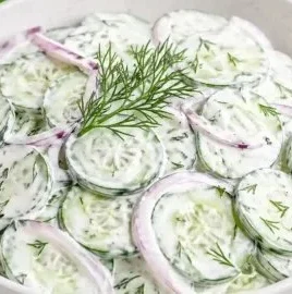 Delicious creamy cucumber salad served in a bowl with fresh herbs