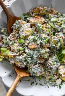 Delicious crispy smashed potato salad served in a bowl with fresh herbs.