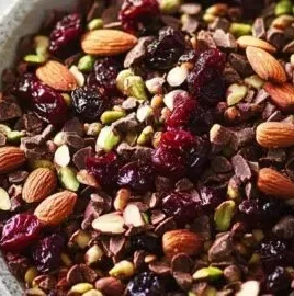 A bowl of dark chocolate-cherry trail mix, a healthy anti-inflammatory snack.