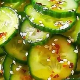 Bowl of Easy Asian Cucumber Salad with fresh tomatoes and sesame seeds
