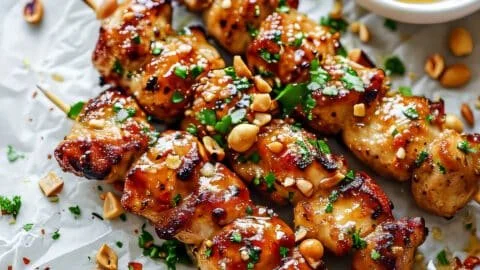 Easy grilled chicken skewers glazed with honey garlic sauce on a grill.
