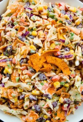 Delicious Frito Cowboy Cabbage served in a bowl, topped with Fritos and cheese.
