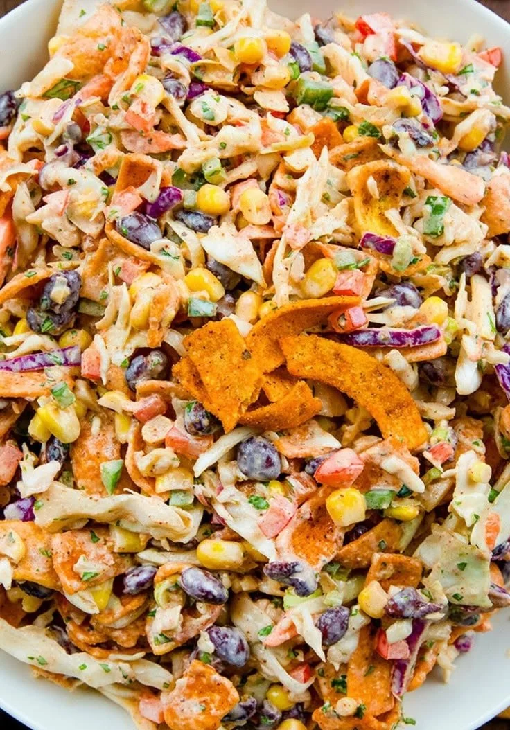 Delicious Frito Cowboy Cabbage served in a bowl, topped with Fritos and cheese.