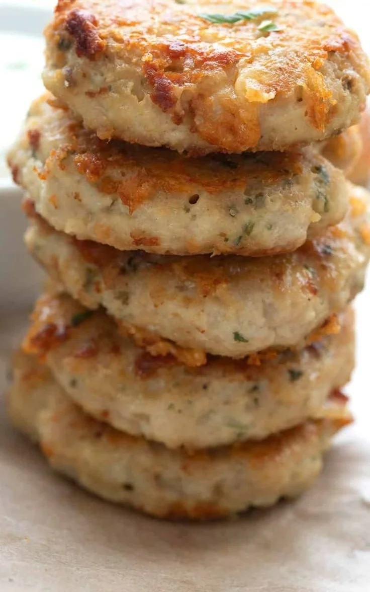 Gluten-free chicken fritters served on a plate with dipping sauce.