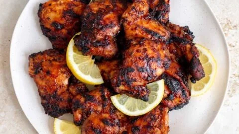 Delicious grilled BBQ chicken thighs on the barbecue grill