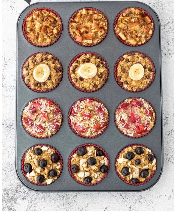 A batch of freshly baked healthy oatmeal muffins on a wooden table.