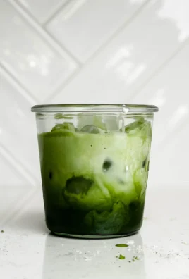 Delicious Iced Matcha Latte served with ice and a sprinkle of matcha powder