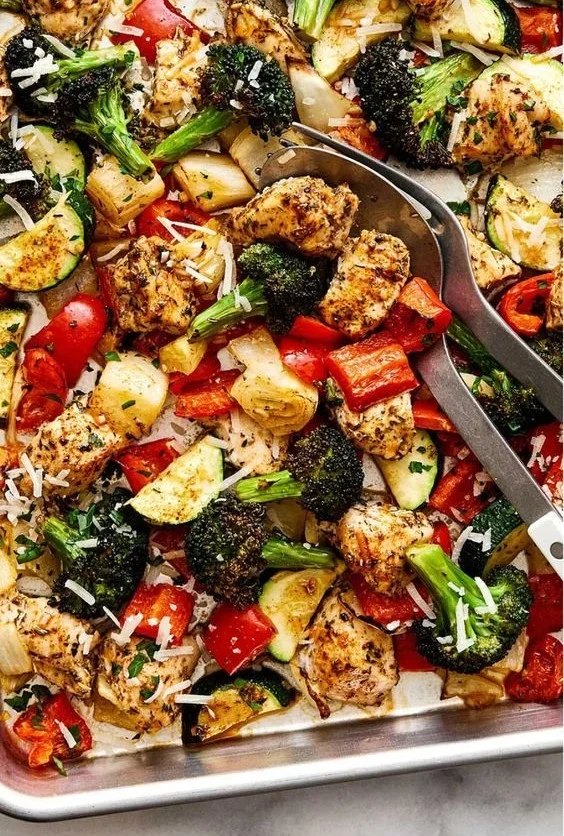 Sheet pan dinner featuring Italian chicken and vegetables, colorful and appetizing.