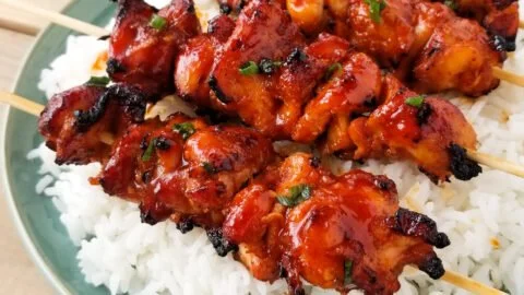 Grilled Korean Chicken Skewers served on a platter with garnish