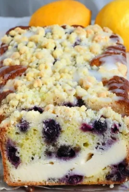 Loaf of lemon blueberry cream cheese bread with fresh blueberries on top
