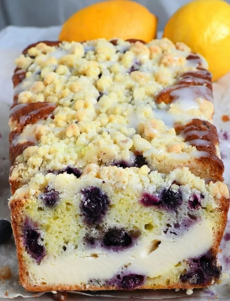 Loaf of lemon blueberry cream cheese bread with fresh blueberries on top