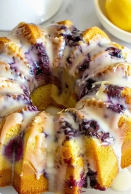 Lemon Blueberry Pound Cake with fresh blueberries and lemon zest on a plate