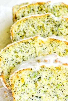Slice of lemon poppy seed zucchini bread on a wooden cutting board