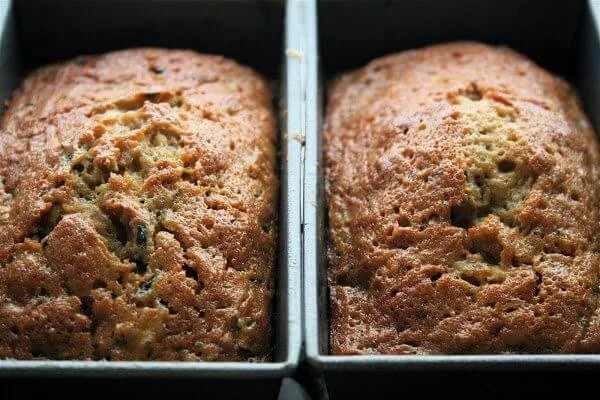 Super-moist zucchini bread freshly baked and served on a wooden table