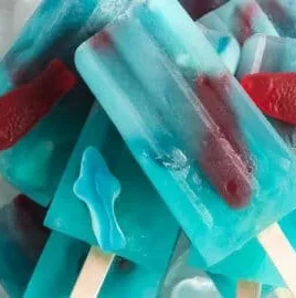 Ocean Blue Lemonade Popsicles in vibrant blue and yellow colors on a summer day