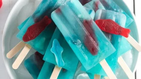 Ocean Blue Lemonade Popsicles in vibrant blue and yellow colors on a summer day
