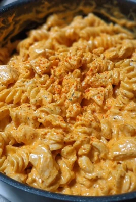 One-Pot Creamy Spicy Buffalo Chicken Pasta in a bowl with vibrant ingredients.
