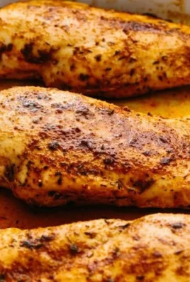 Delicious oven baked chicken breast served with herbs and spices.