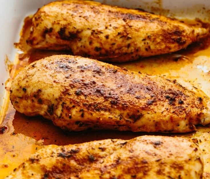 Delicious oven baked chicken breast served with herbs and spices.