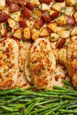 Parmesan Crusted Chicken Sheet Pan Dinner ready to serve with herbs and vegetables.