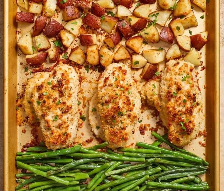 Parmesan Crusted Chicken Sheet Pan Dinner ready to serve with herbs and vegetables.