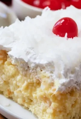 Delicious Pineapple Colada Poke Cake topped with coconut and pineapple slices