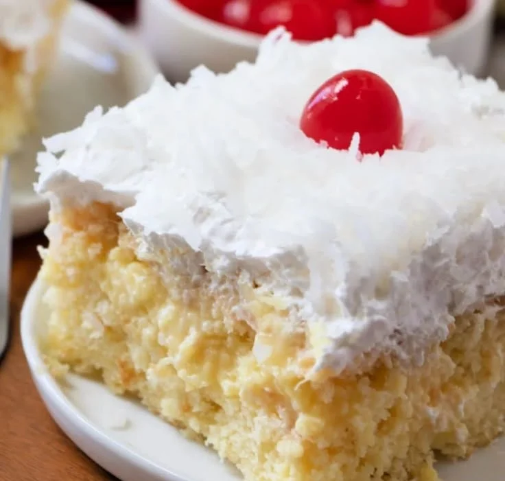 Delicious Pineapple Colada Poke Cake topped with coconut and pineapple slices