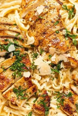 Creamy Chicken Fettuccine Alfredo served on a plate with parsley garnish