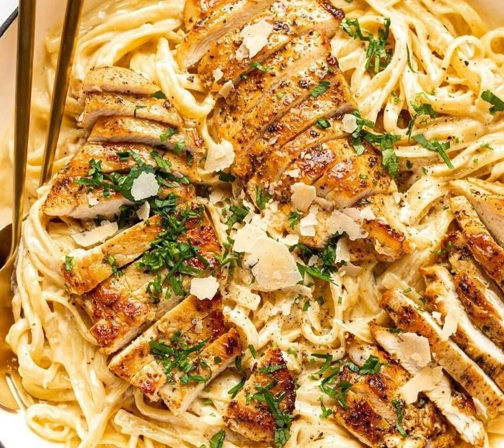 Creamy Chicken Fettuccine Alfredo served on a plate with parsley garnish