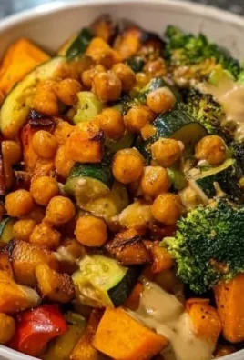 Colorful roasted veggie bowl with assorted vegetables and seasoning.