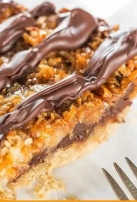 Samoa Pie topped with chocolate and coconut flakes, a rich dessert treat.