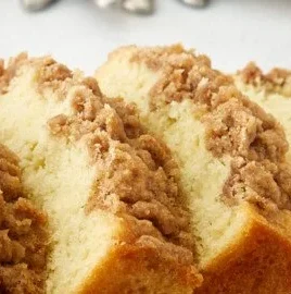 Sour cream coffee cake loaf with a golden crust and crumbly topping