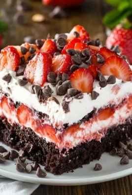 Strawberry Earthquake Cake topped with fresh strawberries and cream.