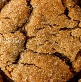 Super soft molasses cookies on a white plate with a festive background