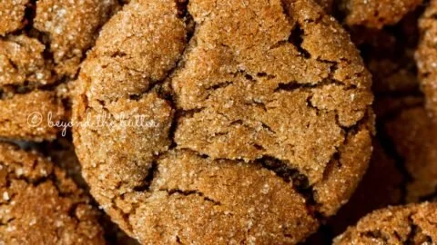 Super soft molasses cookies on a white plate with a festive background