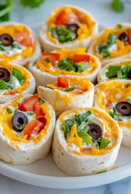 Taco Cream Cheese Pinwheels served as a colorful appetizer on a platter.
