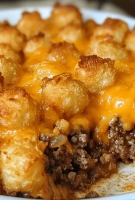 Tater tot casserole topped with golden crispy tater tots and ground beef.