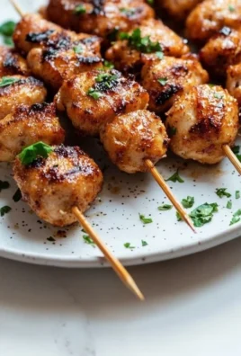 Delicious Thai Chicken Bites served with dipping sauce on a plate.