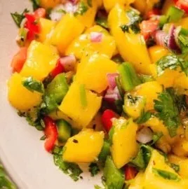 Fresh mango salsa made with ripe mangoes, onions, cilantro, and lime juice