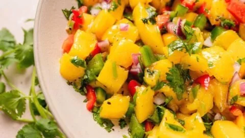 Fresh mango salsa made with ripe mangoes, onions, cilantro, and lime juice