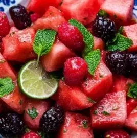 Fresh watermelon salad with lime mint dressing in a bowl